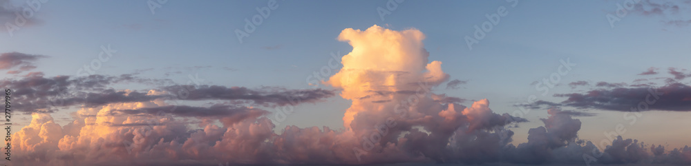 Dramatic Panoramic View of a cloudscape during a dark, rainy and colorful morning sunrise. Taken over Beach Ancon in Trinidad, Cuba.