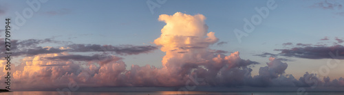 Dramatic View of a cloudscape over the Ocean during a dark, rainy and colorful morning sunrise. Taken over Beach Ancon in Trinidad, Cuba.
