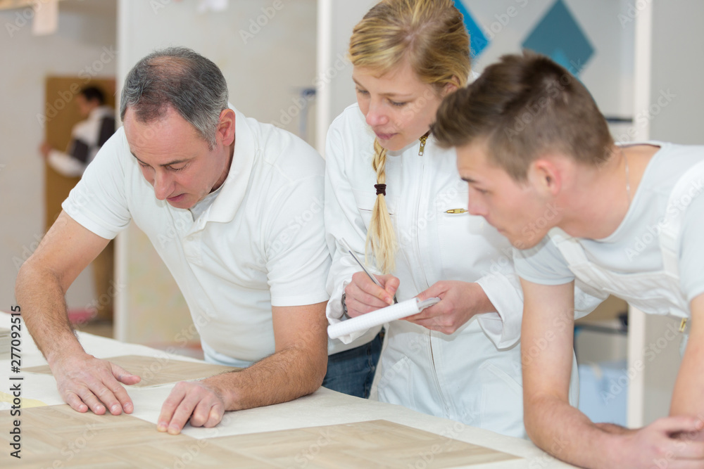 Fototapeta premium female and male apprentices with teacher