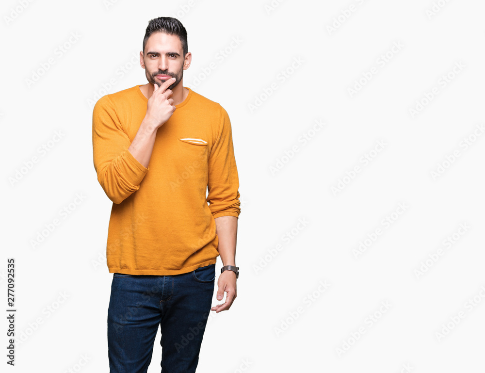 Young handsome man over isolated background looking confident at the camera with smile with crossed arms and hand raised on chin. Thinking positive. Young handsome man over isolated background looking confident at the camera with smile with crossed arms and hand raised on chin. Thinking positive.