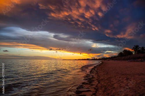 Canvas Print Beautiful View of a sandy beach, Playa Ancon, on the Caribbean Sea in Triniday, Cuba, during a dramatic cloudy sunset