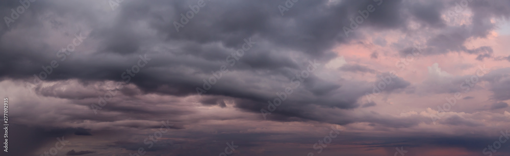 Dramatic Panoramic View of a cloudscape during a dark, rainy and colorful morning sunrise. Taken over Beach Ancon in Trinidad, Cuba.