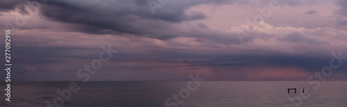 Wallpaper Mural Dramatic Panoramic View of a cloudscape over the Ocean during a dark, rainy and colorful morning sunrise. Taken over Beach Ancon in Trinidad, Cuba. Torontodigital.ca