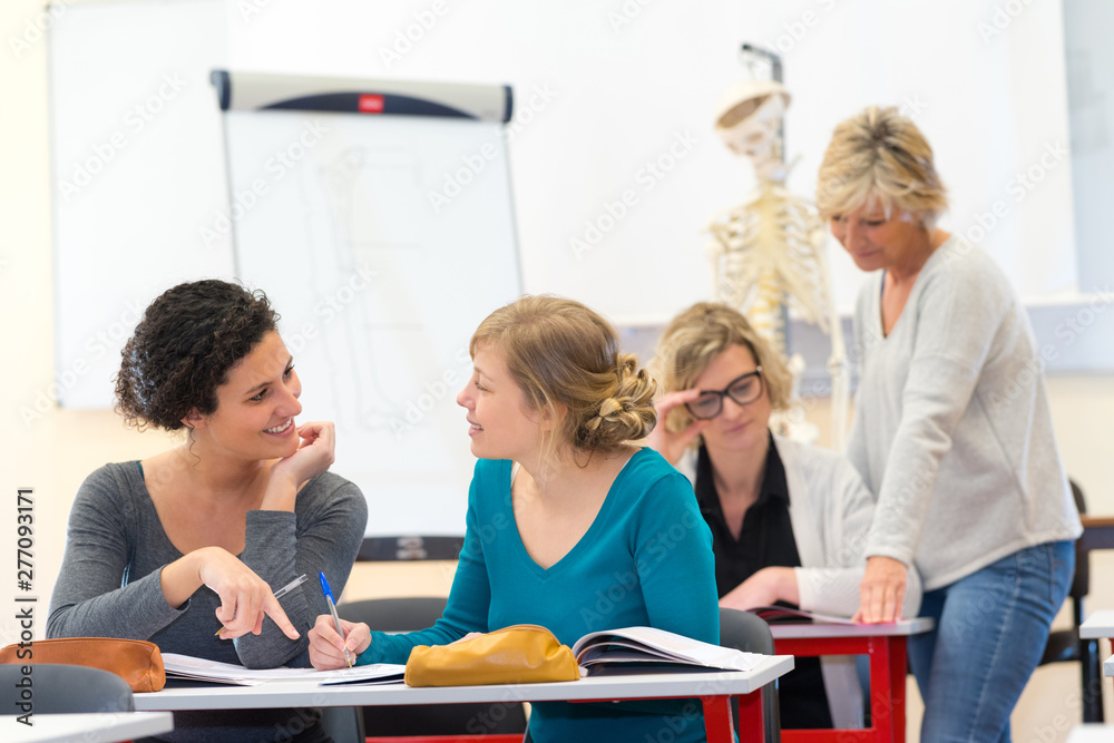 adult female students socializing while in class adult female students socializing while in class