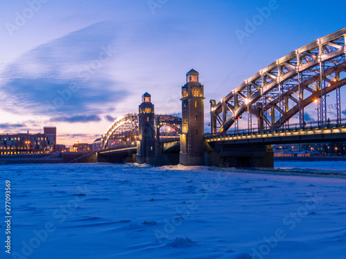 Fototapeta Naklejka Na Ścianę i Meble -  Bolsheokhtinsky Bridge with the frozen Neva River. In St. Petersburg, Russia