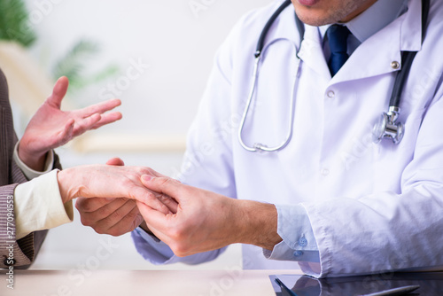 Young doctor examining senior old woman