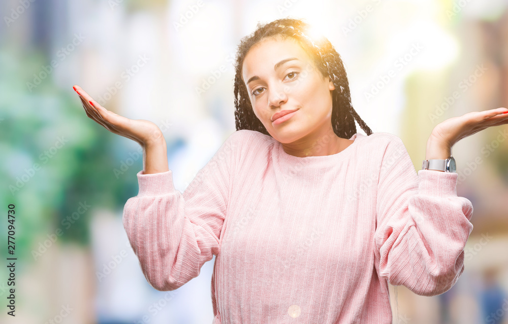 Young braided hair african american girl wearing sweater over isolated background clueless and confused expression with arms and hands raised. Doubt concept. Young braided hair african american girl wearing sweater over isolated background clueless and confused expression with arms and hands raised. Doubt concept.