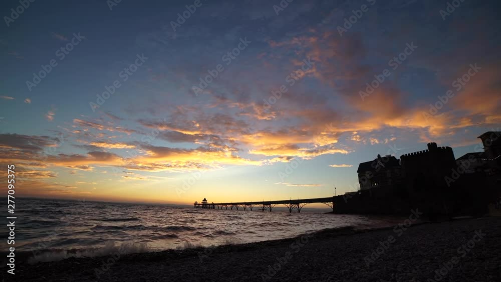 Beautiful vibrant sunset over ocean, with silhouette of pier Beautiful vibrant sunset over ocean, with silhouette of pier