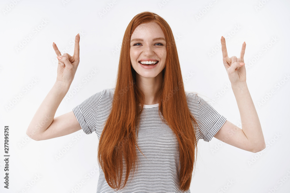 Yeah girl power we rock. Charming funny amused ginger girl long red hair  smiling amazed have fun laughing, show rock-n-roll heavy metal gesture  enjoy exciting good music concert party friends Stock Photo