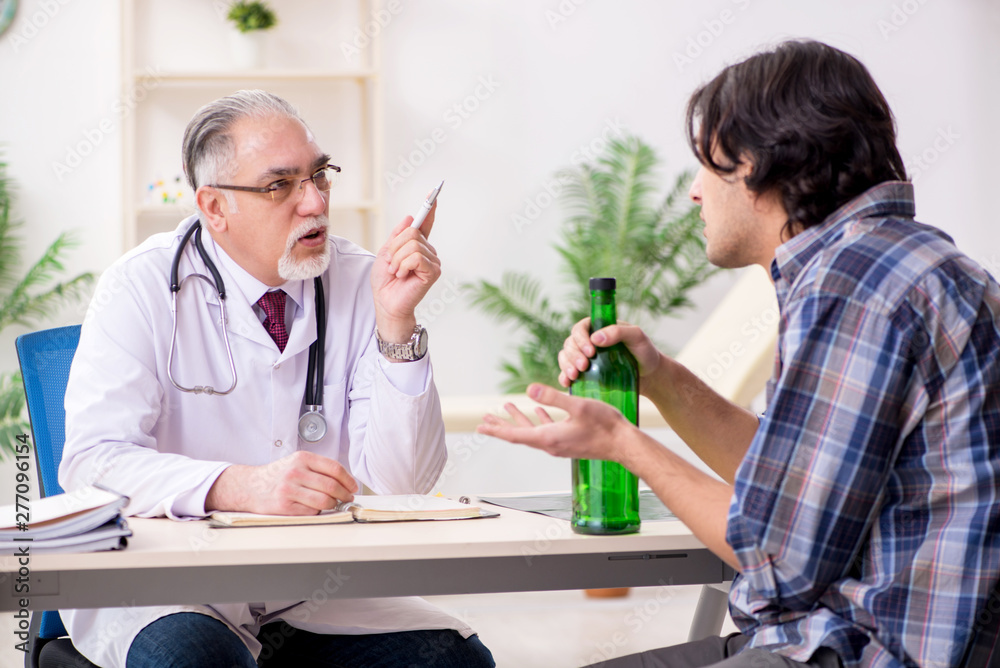 Young male alcoholic visiting old doctor Young male alcoholic visiting old doctor