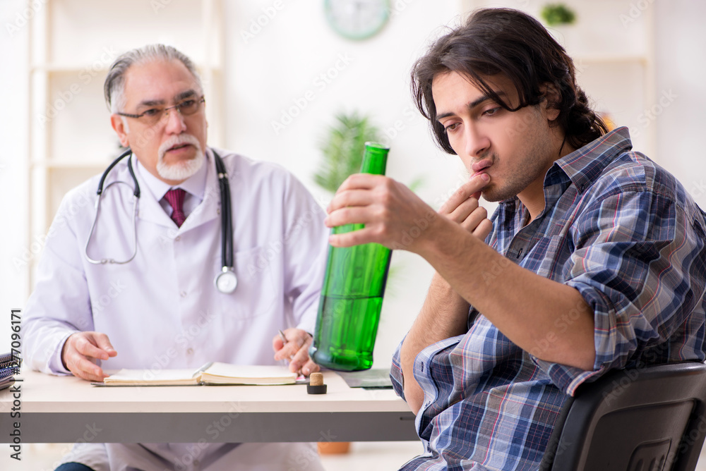 Young male alcoholic visiting old doctor Young male alcoholic visiting old doctor
