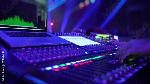 Remote control for adjusting the sound. Audio mixer. Sound engineer adjusts the sound. Music Festival. Change the volume level. Recording studio. Shooting a television show, a concert. Live broadcast.