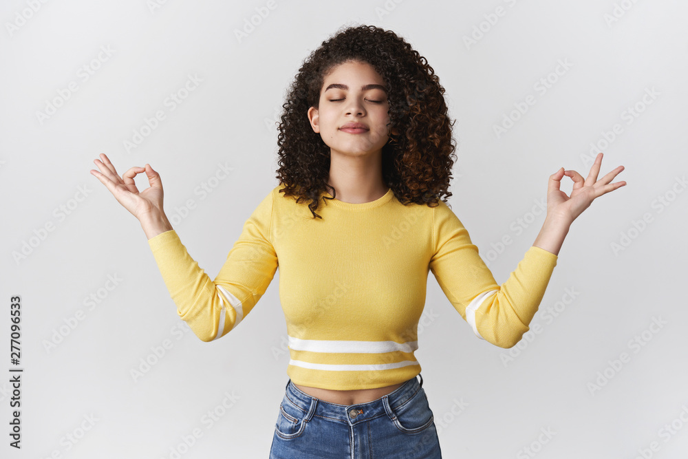 Breathing practice brings peace soul. Charming relaxed carefree meditation stylish girl curly-haired brunette close eyes inhale air raise hands lotus nirvana pose exercise yoga taking break city rush