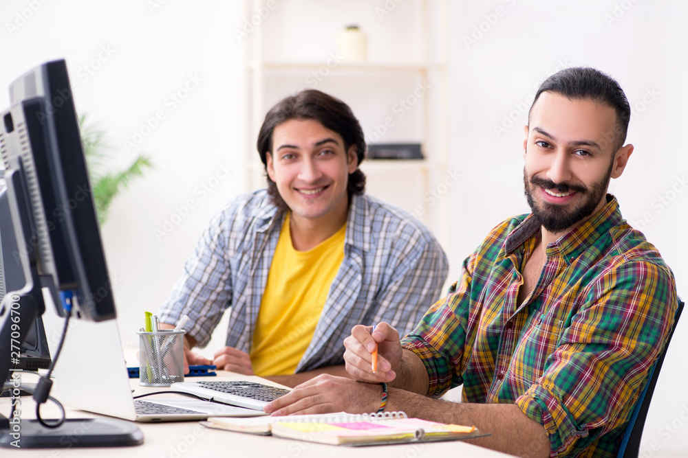 Two it specialists working in the office Two it specialists working in the office