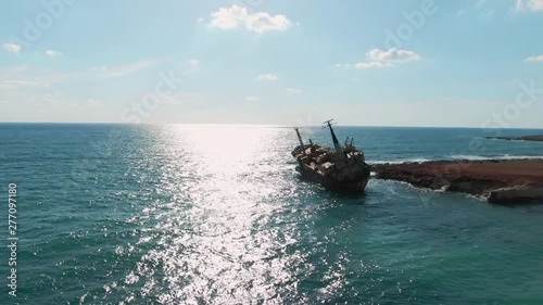 Amazing summer vacation to Cyprus beaches in summer Peyia. Drone view of myterious stranded ship Edro III standing in the sea water near Paphos beach on sunny day. photo