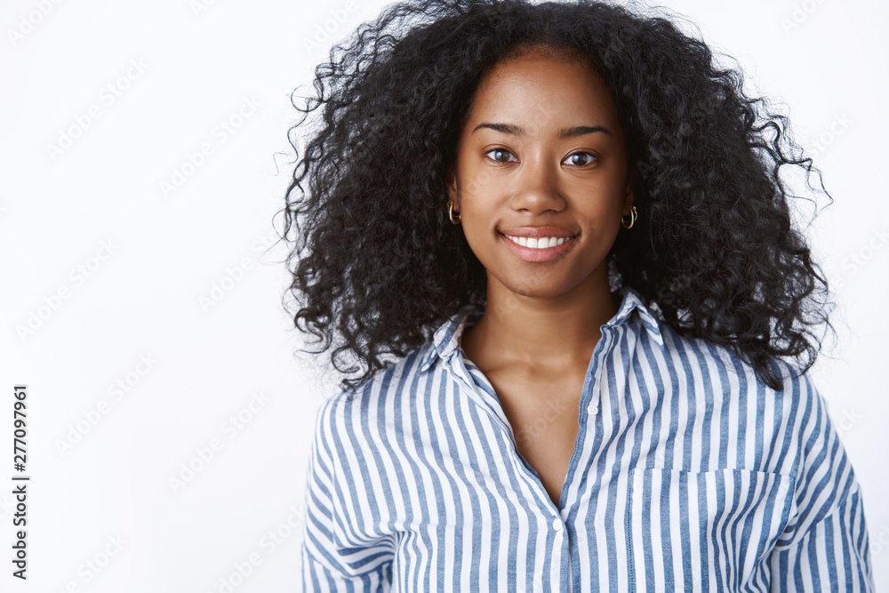 Gorgeous friendly-looking smiling happy dark-skinned girl afro hairstyle wearing office striped blouse look fashionable, ambitious attitude, get ready job interview, standing white background Gorgeous friendly-looking smiling happy dark-skinned girl afro hairstyle wearing office striped blouse look fashionable, ambitious attitude, get ready job interview, standing white background