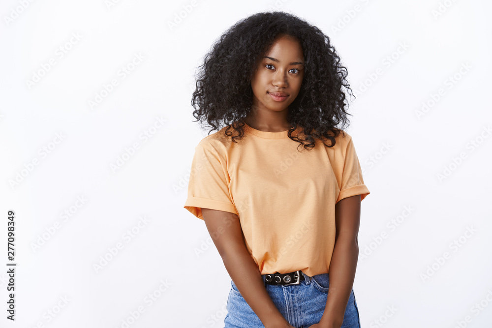 Attractive lovely african american girl university student curly-hairstyle wearing orange trendy t-shirt posing cute white background, smiling looking camera carefree joyful, expressing positivity Attractive lovely african american girl university student curly-hairstyle wearing orange trendy t-shirt posing cute white background, smiling looking camera carefree joyful, expressing positivity