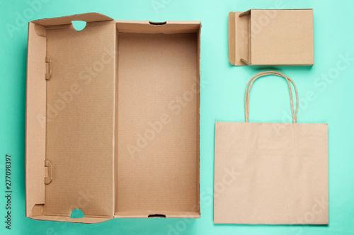 Eco concept. Cardboard boxes, paper bag on blue background. Top view