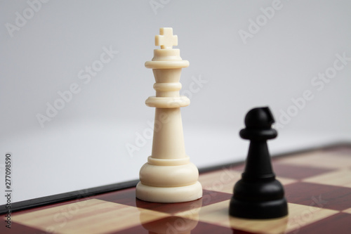  The black pawn comes on the white king. Game of chess. Chess board