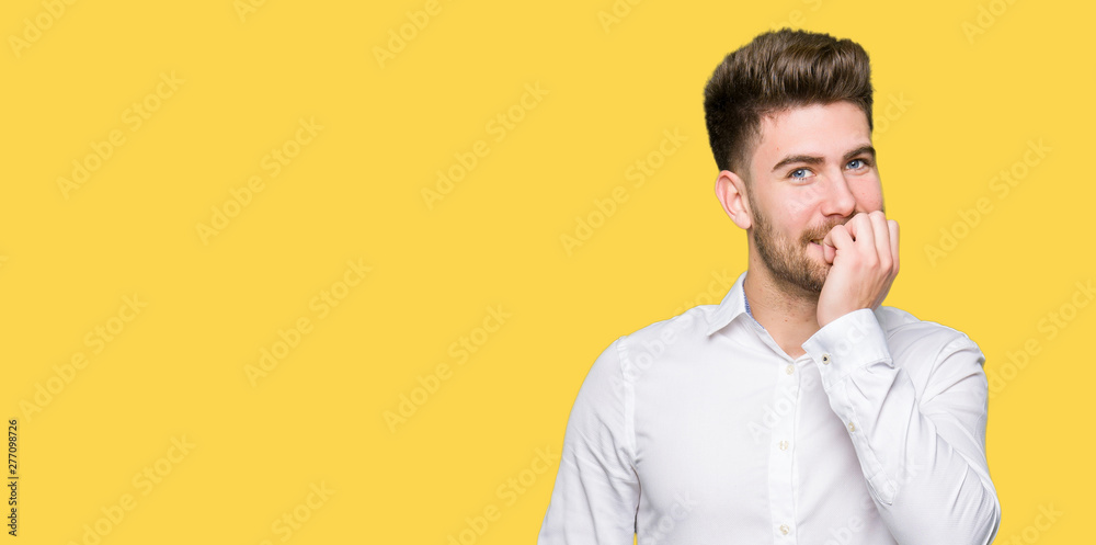 Young handsome business man looking stressed and nervous with hands on mouth biting nails. Anxiety problem. Young handsome business man looking stressed and nervous with hands on mouth biting nails. Anxiety problem.