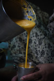 pouring mango shake  into a glass