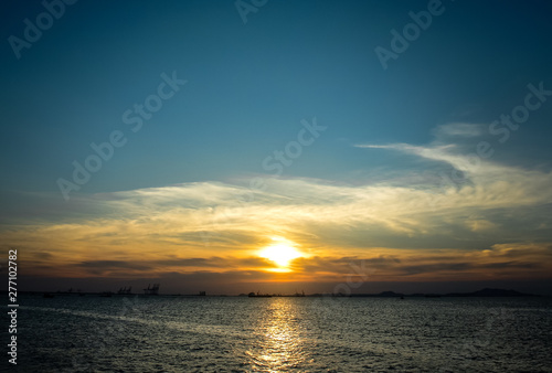 Sunset at sea with clouds and silhouette of island © Beach boy 2024