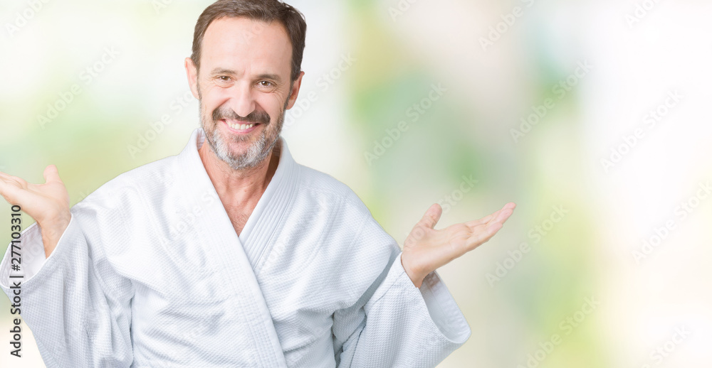 Handsome middle age senior man wearing kimono uniform over isolated background Smiling showing both hands open palms, presenting and advertising comparison and balance Handsome middle age senior man wearing kimono uniform over isolated background Smiling showing both hands open palms, presenting and advertising comparison and balance