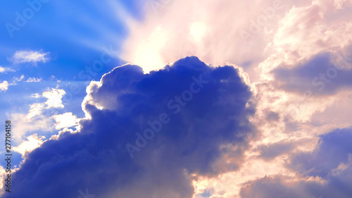 The cloud covered the sun. Halo of sunlight. Blue sky with clouds. Natural background. Warm summer season. © Андрей Михайлов