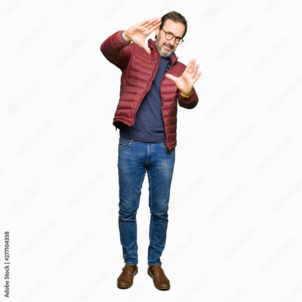 Middle age handsome man wearing glasses and winter coat Smiling doing frame using hands palms and fingers, camera perspective Middle age handsome man wearing glasses and winter coat Smiling doing frame using hands palms and fingers, camera perspective