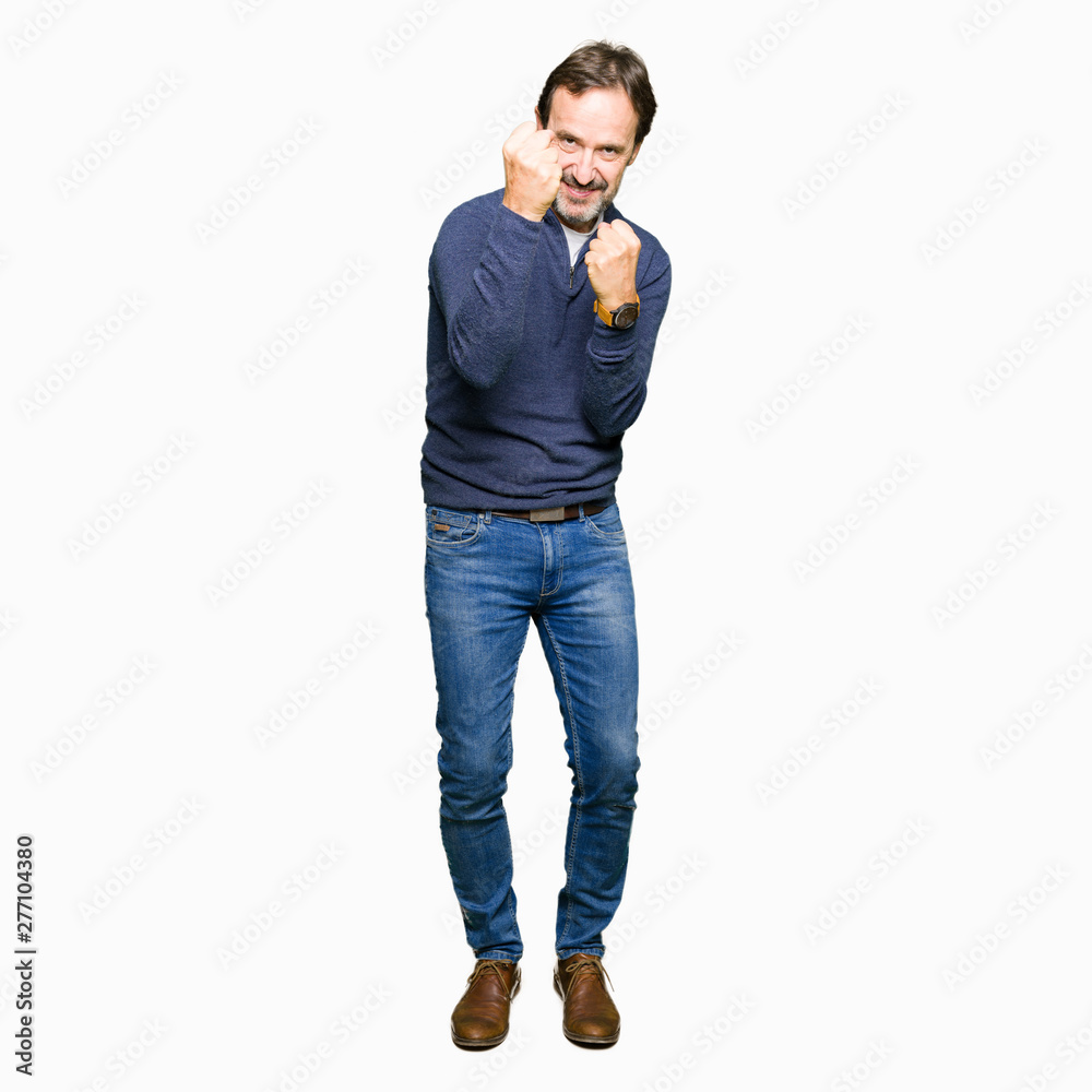Middle age handsome man wearing a sweater Ready to fight with fist defense gesture, angry and upset face, afraid of problem Middle age handsome man wearing a sweater Ready to fight with fist defense gesture, angry and upset face, afraid of problem