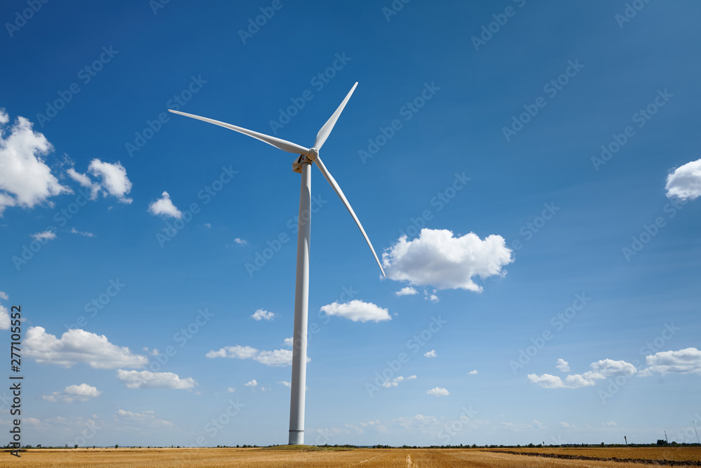wind generator on bright cloudy sky background wind generator on bright cloudy sky background
