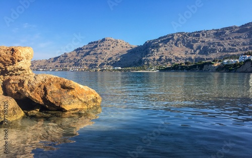 A view across the sea from a beautiful bay in Pefkos, Rhodes photo