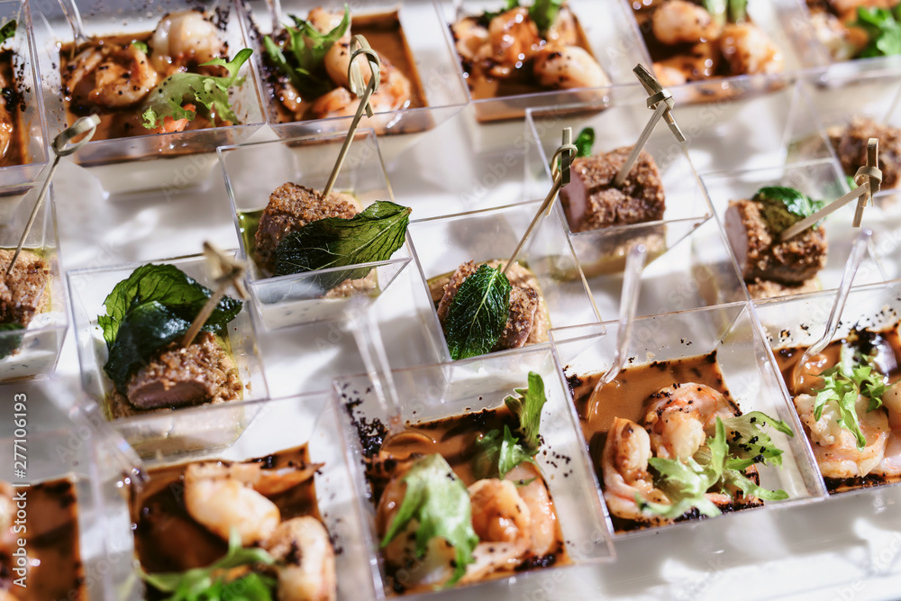 Tray of snacks at a banquet or reception. Catering buffet at party. Buffet table welcome drink concept Tray of snacks at a banquet or reception. Catering buffet at party. Buffet table welcome drink concept