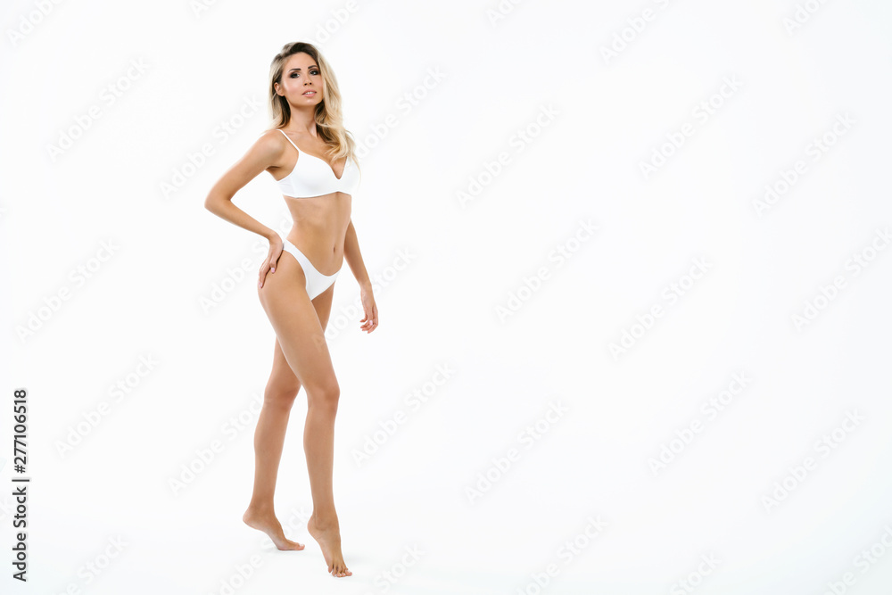 Beauty perfect slim body: fit and sporty girl in underwear. Beautiful and healthy woman posing at white background. Sport, wellness, fitness, diet, weight loss and healthcare concept. Beauty perfect slim body: fit and sporty girl in underwear. Beautiful and healthy woman posing at white background. Sport, wellness, fitness, diet, weight loss and healthcare concept.