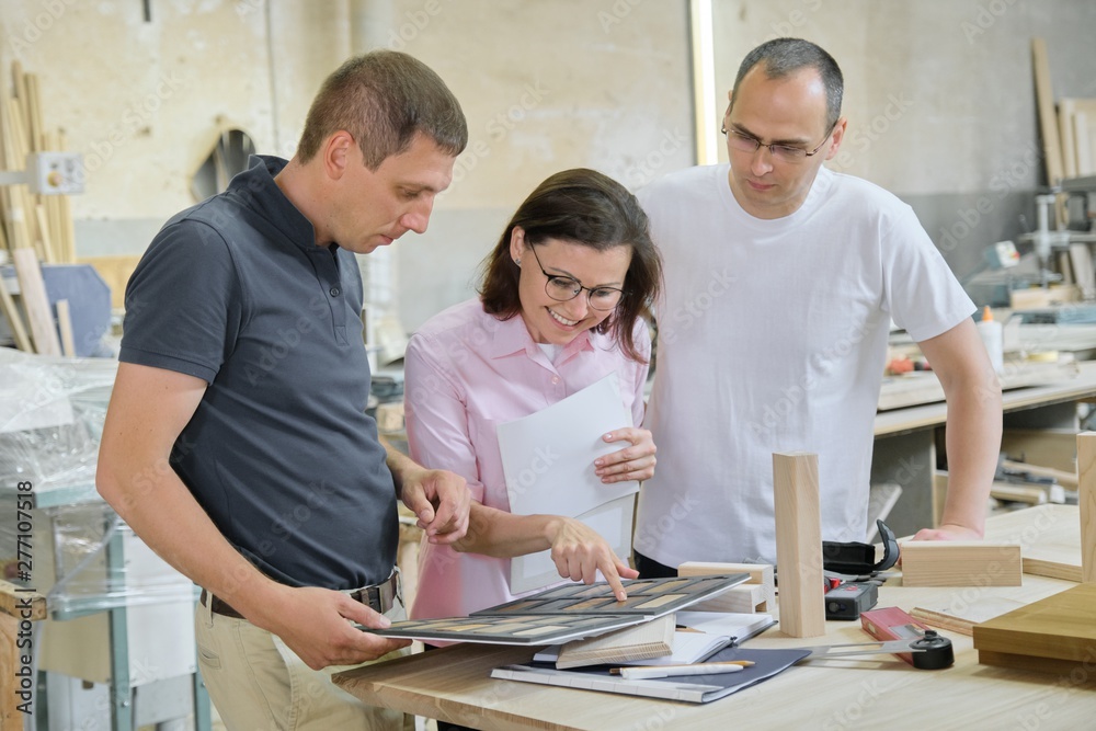 Group of people designer, client, carpenter, engineer choosing wooden products