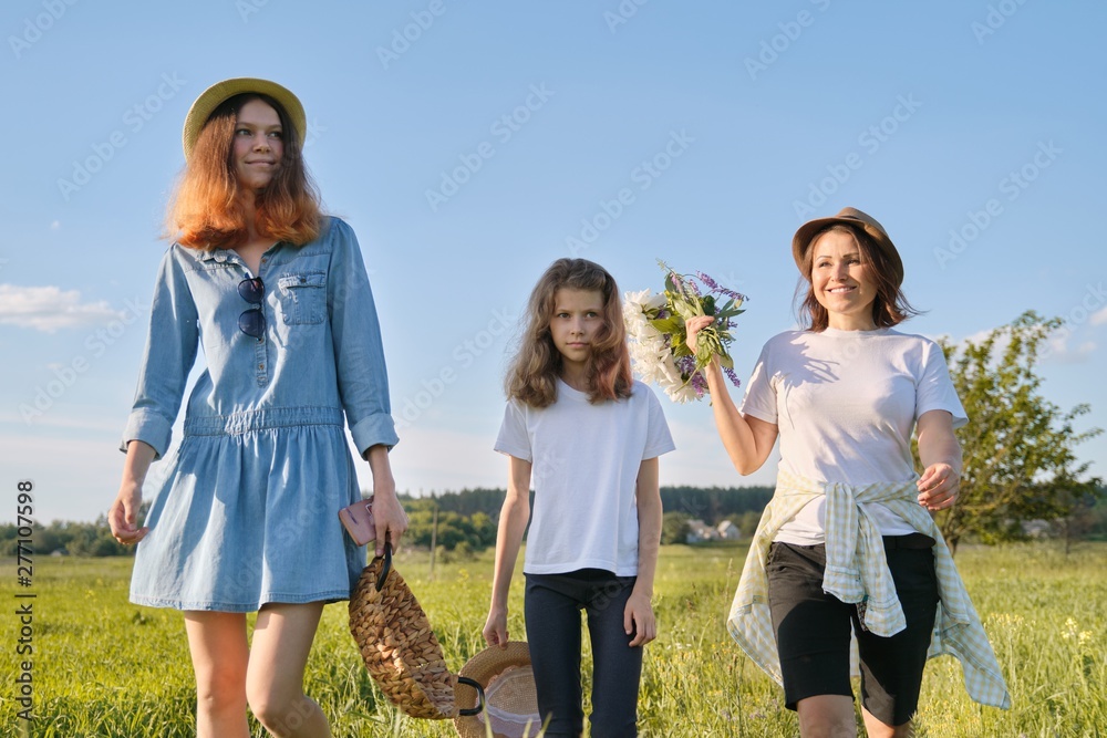 Mother with children two daughters walking along country road Mother with children two daughters walking along country road