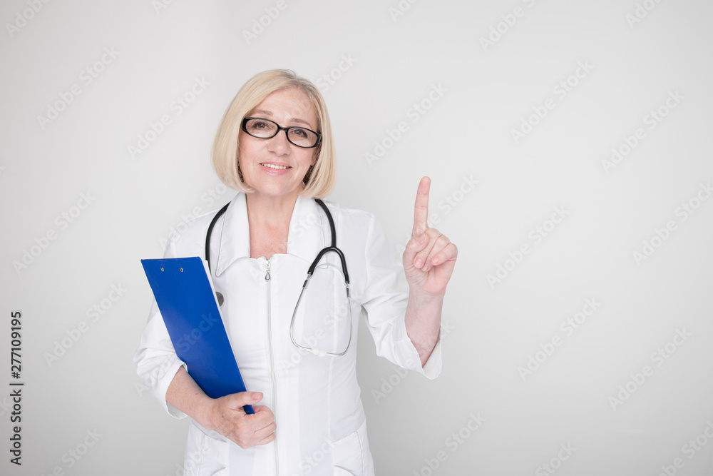 Portrait of female doctor pointing something isolated in the white studio Portrait of female doctor pointing something isolated in the white studio
