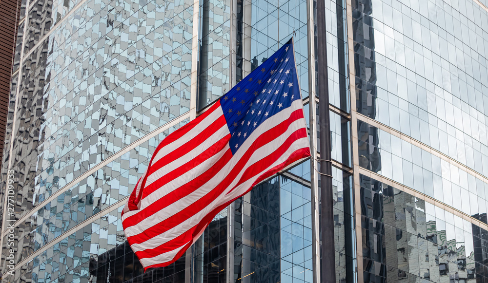 American flag in Chicago, Illinois downtown. Glass facade buildings background.