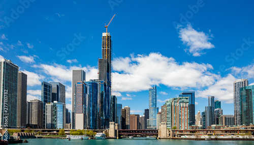Chicago city skyscrapers on the river canal, blue sky background