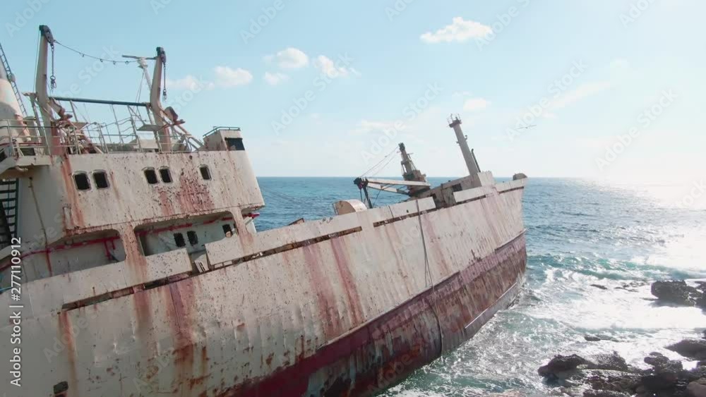 Panoramic view of most popular shipwreck on Cyprus. Drone footage of the big abandoned insudtrial ship standing in the sea water on the shore near the island. Summer tour. Panoramic view of most popular shipwreck on Cyprus. Drone footage of the big abandoned insudtrial ship standing in the sea water on the shore near the island. Summer tour.