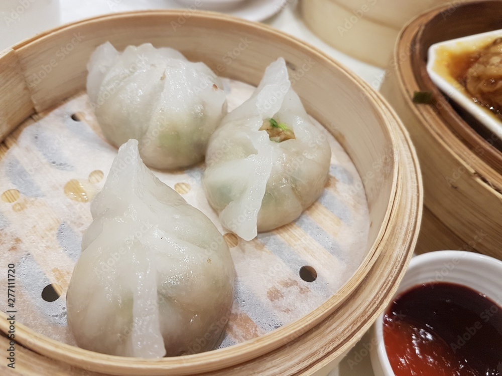 In the picture is steam dumpling. This is a famous hong kong food. It is a type of traditional chinese dumpling. In the picture is steam dumpling. This is a famous hong kong food. It is a type of traditional chinese dumpling.