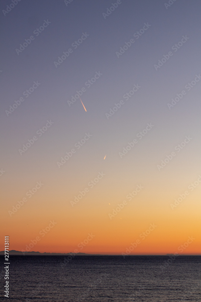 airplane wake at sunset with the background of the mountains of South Africa airplane wake at sunset with the background of the mountains of South Africa