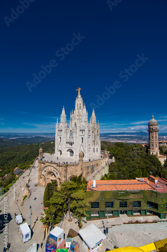 Barcelona, Spain - April, 2019: Tibidabo Cathedral. Temple of the Sacred Heart of Jesus at Mount Tibidabo. Barcelona, Spain. Blue sky with cloud of spring day. Famous landmark in Catalonia.