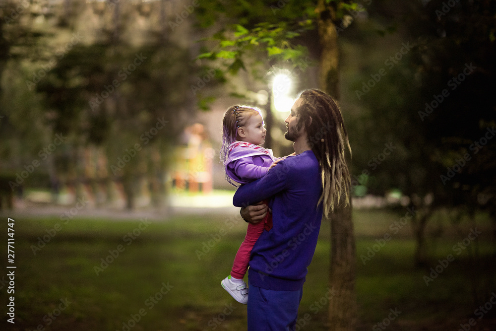 dad and daughter,with dreadlocks walking in the Park dad and daughter,with dreadlocks walking in the Park