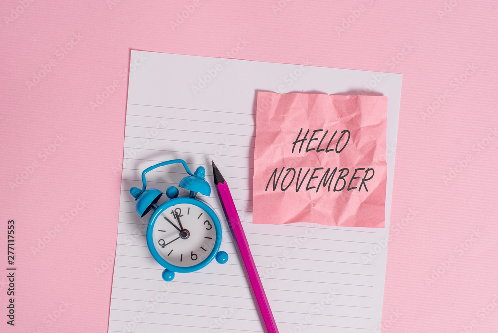 Writing note showing Hello November. Business concept for Welcome the eleventh month of the year Month before December Striped paper sheet note pencil vintage alarm clock colored background Writing note showing Hello November. Business concept for Welcome the eleventh month of the year Month before December Striped paper sheet note pencil vintage alarm clock colored background