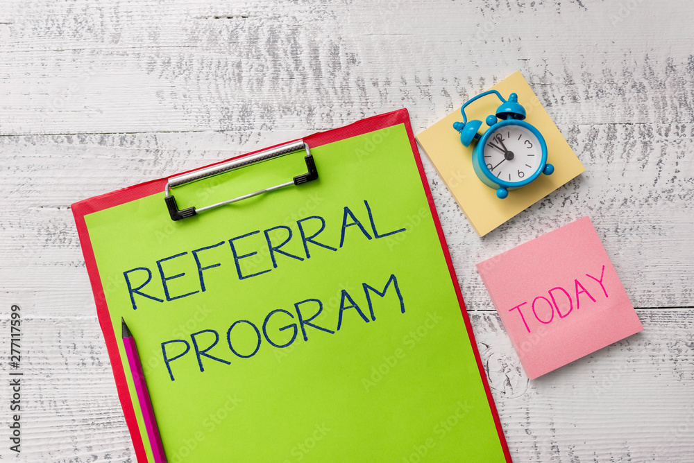 Handwriting text Referral Program. Conceptual photo employees are rewarded for introducing suitable recruits Metal clipboard sheets marker alarm clock notes pad wooden background
