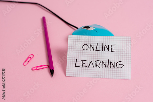 Word writing text Online Learning. Business photo showcasing Larning with the assistance of the Internet and a computer Wire vintage mouse clips marker squared paper sheet colored background photo