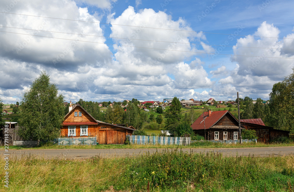 Russian village in summer, view of the russian tradtional country houses. Village of Visim, Sverdlovsk region, Russia.