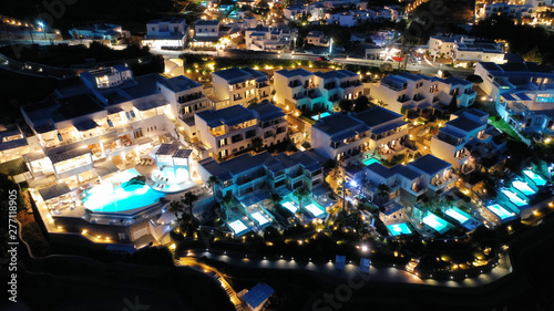 Aerial drone night shot of famous Psarou beach with luxury resorts and yachts docked, Mykonos island, Cyclades, Greece photo