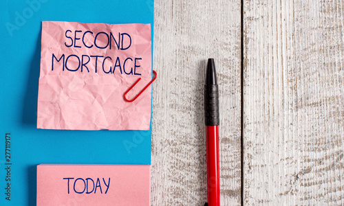 Handwriting text Second Mortgage. Conceptual photo lien on property which is subordinate to more senior one Wrinkle paper and cardboard plus stationary placed above wooden background photo